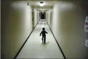  ?? GREGORY BULL — THE ASSOCIATED PRESS FILE ?? An asylum-seeking boy from Central America runs down a hallway after arriving from an immigratio­n detention center to a shelter in San Diego.