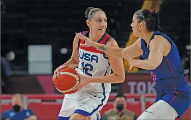  ?? Associated Press ?? On the move: United States' Diana Taurasi (12) drives around Serbia's Sasa Cado (6) during the women's basketCBMM TFNJmOBM HBNF BU UIF 4VNNFS 0MZNQJDT JO 4BJUBNB +BQBO