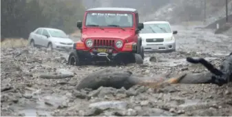 ?? STAN LIM/THE ORANGE COUNTY REGISTER VIA AP ?? A mudslide trapped several vehicles on Thursday along Valley of the Falls Drive in Forest Falls in San Bernardino County, California.