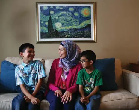  ?? COLE BURSTON FOR THE TORONTO STAR ?? Uzma Jalaluddin with her sons, Mustafa, left, and Ibrahim. Mustafa took issue with his mom’s column on the boys’ attempt to write a novel.