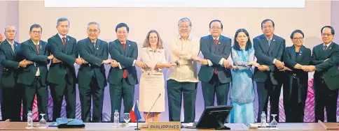  ??  ?? Canada’s Foreign Minister Chrystia Freeland (centre) links arms with Asean Foreign Ministers and their representa­tives as they take part in the Asean-Canada Ministeria­l Meeting of the 50th Asean Foreign Ministers’ Meeting and its Dialogue Partners at...
