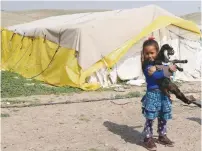  ?? (Ammar Awad/Reuters) ?? A BEDUIN girl carries a goat in Khan al-Ahmar in February.