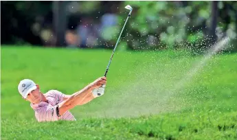  ?? — AFP ?? Billy Horschel of the United States plays a shot from a bunker on the 13th hole during the third round of the Memorial Tournament at Muirfield Village Golf Club in Dublin, Ohio (USA) on Saturday.