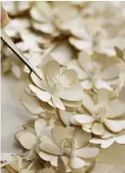  ??  ?? A pastel wreath includes intricate laser-cut butterflie­s – tweezers help with the delicate assemblage. Suzi’s finished designs look just like an authentic bunch of posies