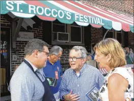  ?? DARREL ROWLAND / COLUMBUS DISPATCH ?? Mike DeWine (center) and his wife, Fran, talk with Matt Daniels, St. Rocco Parish School principal, at the Cleveland school’s festival.