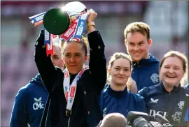  ?? ?? Jo Potter lifts the trophy after seeing her side to a 4- 1 victory