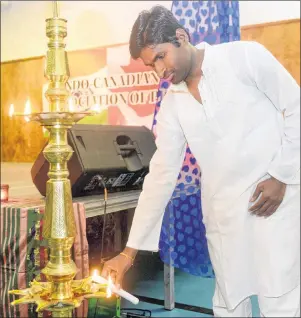  ?? MITCH MACDONALD/THE GUARDIAN ?? Indo-Canadian Associatio­n of P.E.I. secretary treasurer Hari Pulipati lights a lamp near the start of the Diwali dinner hosted by the associatio­n at Cornwall’s APM Centre on Sunday. It’s a tradition for the event to begin with the lighting of the lamp,...