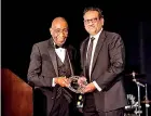  ?? ?? Dean Robert Johnson, MD, giving Dr Nagendran the Distinguis­hed Alumni Award (Photo credit: John O'Boyle)