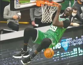  ?? AP PHOTO ELISE AMENDOLA ?? Boston Celtics center Tacko Fall (99) dunks during the fourth quarter of an NBA basketball game against the Orlando Magic, Friday in Boston.