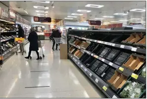  ?? (David Young/PA via AP) ?? Shelves in a Sainsbury’s supermarke­t in Belfast are depleted Monday. Brexit rules are disrupting food supplies, businesses warn.