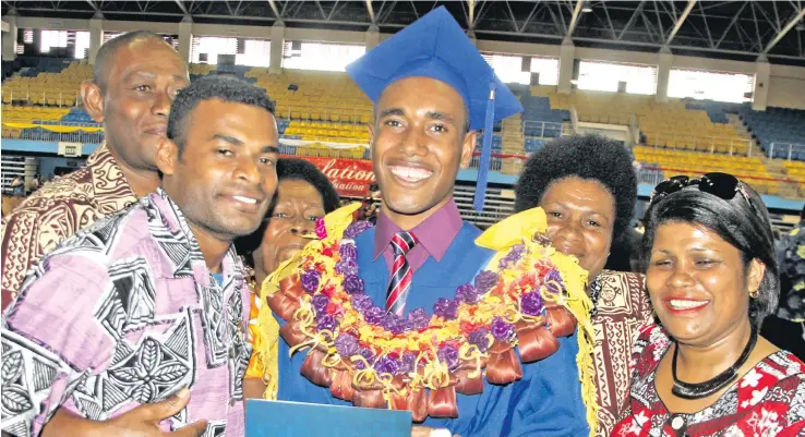  ?? Photo: Ronald Kumar ?? Alivoso Iosefo Rauto (middle) with his family after graduating with a Bachelor of Education from the Fiji National University at the Vodafone Arena, Suva, on December 13, 2017.