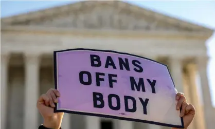  ?? ?? A pro-choice demonstrat­or in Washington. The supreme court is poised to severely weaken or overturn Roe later this year. Photograph: Evelyn Hockstein/Reuters