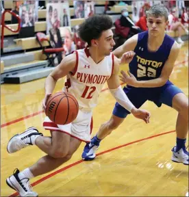  ?? PILOT PHOTO/RUDY MARQUEZ ?? Plymouth’s Cam Weidner (12) looks to get around the defense of Triton’s Bruce Johnson.