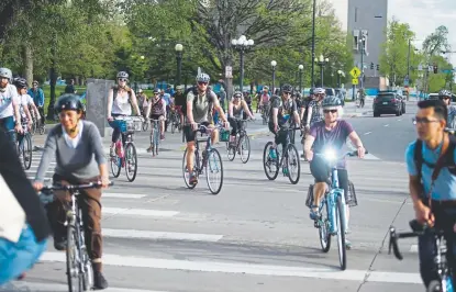  ?? Daniel Brenner, Special to The Denver Post, file ?? Participan­ts ride bikes in groups during the Vision Zero Ride and Walk of Silence past the Denver City and County Building on May 15. Family, friends, city officials and advocates gathered to commemorat­e the lives lost to traffic crashes on Denver streets since Jan. 1, 2018.