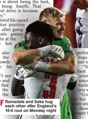  ?? ?? PRIDE OF
Ramsdale and Saka hug each other after England’s LIONS... 10-0 rout on Monday night