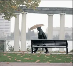  ?? JANE TYSKA — BAY AREA NEWS GROUP ?? A man walks past the Pergola at Lake Merritt as a light rain falls in Oakland, on Monday.