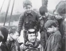  ??  ?? 0 Frogman Lionel ‘Buster’ Crabbe, who vanished today in 1956, chats to children on Mull in 1950