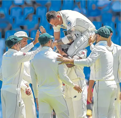  ?? Picture: CHRISTIAAN KOTZE/AFP ?? HIGH FIVES: Dale Steyn is hoisted high and handsome by teammates after taking Fakhar Zaman’s wicket to eclipse Shaun Pollock as SA’s highest wicket-taker with 422 wickets in the first Test between the Proteas and Pakistan at SuperSport Park on Wednesday