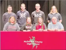  ?? RICK PECK/SPECIAL TO MCDONALD COUNTY PRESS ?? Kristen Cornell (bottom, second from left) recently signed a letter of intent to play softball at Allen County Community College in Iola, Kan. Front row, left to right, is Sheila Cornell (mom), Kristen Cornell, Kaylee Cornell (sister) and Randy Cornell (dad). Back row are MCHS coaches Skyler Rawlins, Kyle Smith, Lee Smith and Heath Alumbaugh.