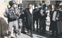  ?? (Ammar Awad/Reuters) ?? POLICE OFFICERS DETAIN a haredi Jew during a protest against coronaviru­s restrictio­ns in Jerusalem earlier this year.