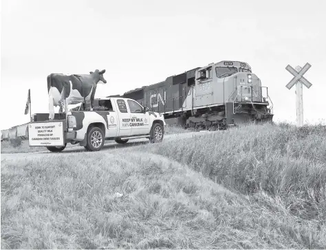  ?? [SUBMITTED] ?? Not only do cars honk to support Canadian milk, but so does this train conductor. Henk Schuurmans has recovered from his injuries from the previous tragic trip and is continuing the milk tour with his daughters, Emily and Lize.