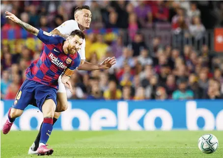  ?? AFP ?? Barcelona's Argentine forward Lionel Messi against Sevilla's Brazilian midfielder Fernando during their Spanish league football match Sunday.