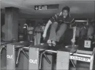  ?? THE ASSOCIATED PRESS ?? In this June 27, 1980 file photo, a man jumps a turnstile in the New York City subway system.