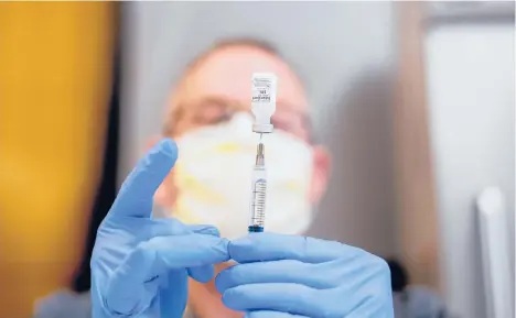  ?? BERGER/AP NOAH ?? A pharmacist draws saline while preparing a dose of COVID-19 vaccine last week in Sacramento, Calif. Virus mutations are causing concern.