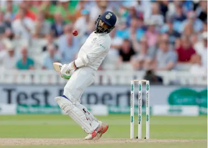  ?? AFP ?? India’s Dinesh Karthik takes action to avoid a bouncer during the opening Test against England. The Indian batsmen apart from Kohli have struggled to handle the England pace attack. —