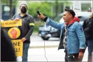  ??  ?? Max Cisneros, with New Haven Pride Center, leads people in a chant before speaking at the event Saturday.