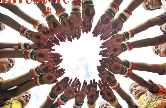  ??  ?? Indian girls wear tri color bangles practice prior to take part during Independen­ce Day celebratio­ns in Secunderab­ad, the twin city of Hyderabad, on August 15, 2017. Indian Independen­ce Day is celebrated annually on August 15, and this year marks 70...