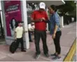  ?? MARTA LAVANDIER/THE ASSOCIATED PRESS ?? Wilman Hernandez and his wife Brenda Ramirez, check their phones for the location of shelters.