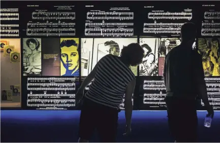  ??  ?? Candace Wilson, left, and Brad Flory, of Mason, Mich., look at photos of Elvis Presley during a tour of the Mississipp­i River Museum at Mud Island River Park on Aug. 12, 2017. YALONDA M. JAMES/THE COMMERCIAL APPEAL