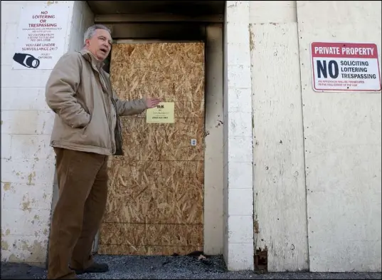  ?? K.M. Cannon Las Vegas Review-Journal @KMCannonPh­oto ?? Donald Walford talks to a reporter at the Alpine Motel Apartments in downtown Las Vegas on Dec. 30. Walford snapped a photo of the bolted back door of the building on Oct. 8. He said the door was not bolted when he checked days later.