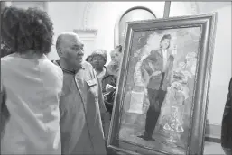  ?? KIM HAIRSTON/BALTIMORE SUN ?? Lawrence Lacks, the oldest son of Henrietta Lacks, looks at a portrait of his mother during an unveiling in the Baltimore City Hall rotunda. Lacks’ cells, later named HeLa cells, were taken without her consent while she was being treated at Johns Hopkins hospital for cervical cancer in 1951. Lacks died later that year, but her cells became the first immortal human cell line.