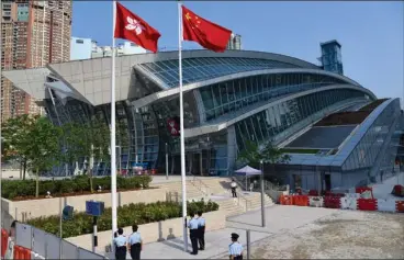  ??  ?? The national and Hong Kong SAR flags flutter outside the Hong Kong’s West Kowloon Station, which will go into service on Sept 23.