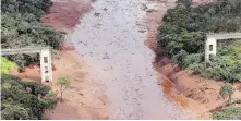  ??  ?? An aerial view of a destroyed bridge on Saturday, the day after a dam holding mine waste collapsed.