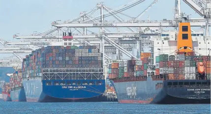  ?? Ben Margot, The Associated Press ?? Container ships are unloaded this week at the Port of Oakland, Calif. The Commerce Department announced Friday that the U.S. economy slowed during the second quarter, a period covering April to June.