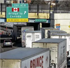  ?? RYAN GARZA/DETROIT FREE PRESS VIA AP ?? Trucks line up Tuesday on northbound I-75 in Detroit as the Ambassador Bridge entrance is blocked off for travel to Canada by truckers protesting vaccine mandates and other COVID-19 restrictio­ns.