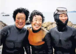  ?? REUTERS ?? Senior haenyeo, also known as “sea women,” Jung Sun-ja, 84, Yoon Yeon-ok, 74, and Ko Keum-sun, 69, pose for a photograph after working in the sea in Busan, South Korea, on April 6.