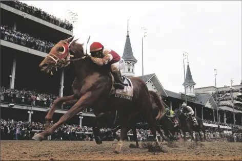  ?? JEFF ROBERSON/AP ?? RICH STRIKE (21), WITH SONNY LEON ABOARD, wins the 148th running of the Kentucky Derby at Churchill Downs on Saturday in Louisville, Ky.