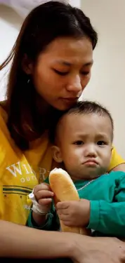  ??  ?? FAMILY: Hoang Thi Thuong and her son at home in Vietnam. Her husband Nguyen Dinh Tu is feared to be among the 39 victims