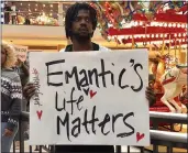  ?? KIM CHANDLER — THE ASSOCIATED PRESS ?? Elijah King holds a sign during a protest at the Riverchase Galleria mall in Hoover, Ala., on Saturday over the police shooting of Emantic Fitzgerald Bradford Jr.