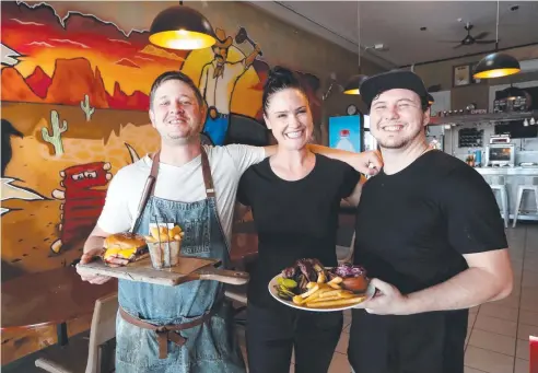  ?? Picture: STEWART McLEAN ?? Slap & Pickle Low N Slow BBQ Smokehouse’s Daithi Spalding with staff Liza Tilley and Cameron Pitcher.