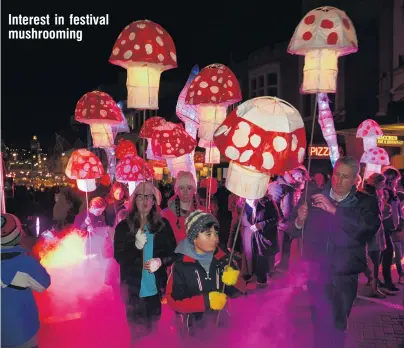  ?? PHOTO: STEPHEN JAQUIERY ?? Children carry illuminate­d fungi up Stuart St during the Dunedin Midwinter Carnival on Saturday. Interest in festival mushroomin­g