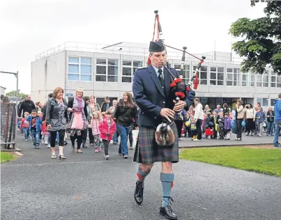  ?? Pictures: Louis Flood. ?? Piper Adam Scrimgeour led the parade to the new building.