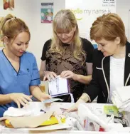  ??  ?? Fears: Nicola Sturgeon delivers a baby box