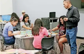  ?? [PHOTO BY NATE BILLINGS, THE OKLAHOMAN] ?? Santa Fe South Schools Superinten­dent Chris Brewster talks with student council members as they prepare for a back-to-school bash Monday inside the new high school building at Plaza Mayor in Oklahoma City.