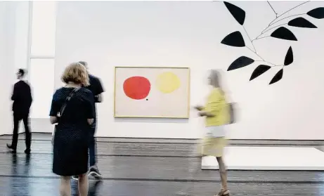  ?? Elizabeth Conley/Staff file photo ?? The author says he escapes from politics through the arts. A media tour walks by Joán Miró’s painting “The Magic of Color” and Alexander Calder’s mobile “The Y” before Houston’s Menil Collection reopened in 2018 after a yearlong installati­on.