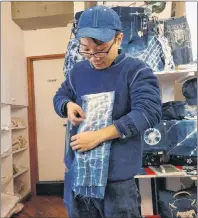  ?? AP PHOTO ?? An instructor demonstrat­ed a folding technique for designing indigo dyed fabric at Wanariya workshop in Tokyo.